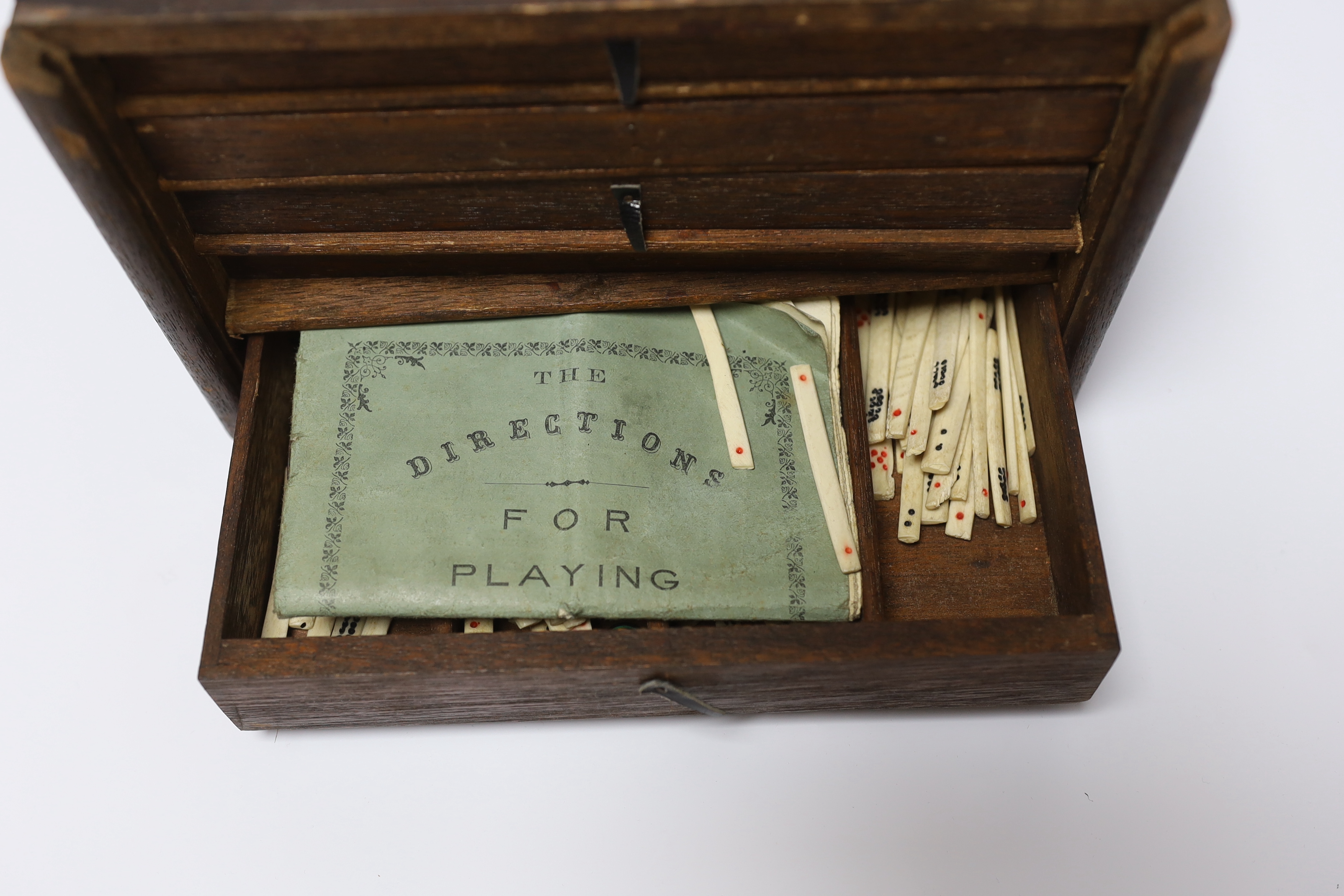 A cased Chinese Mahjong set, bone pieces